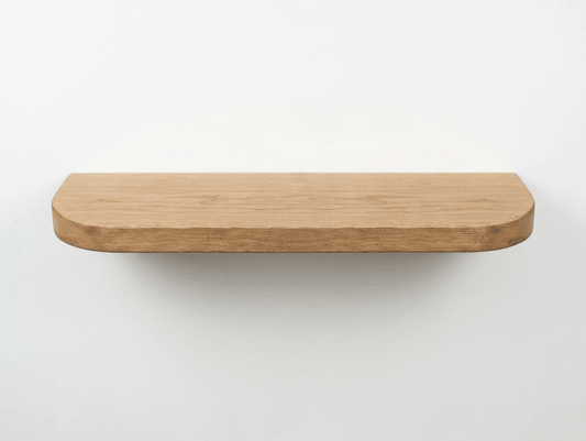 Oak floating shelf with smooth curved edge showing natural grain by Farm Furniture